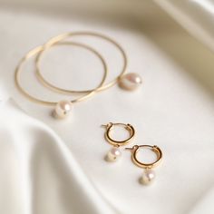 Designer: OFINA An everyday classic. Polished pearl mini hoops to give you a classic modern look. Available in 2 sizes. Small Size: 15mm Hoop w/ 7-8mm Freshwater Pearl Large Size: 18mm Hoop w/ 10mm Freshwater Pearl Material & Care 14k Gold Filled Stone: Freshwater Pearl Hypoallergenic Can be worn in water For more info: Jewelry Care How to Wear Lovely alone or stack the two sizes together. Can also be paired with your favorite huggies and studs! Free Shipping & Repairs within 30 days Classic Pearl Huggie Jewelry, Formal Minimalist Hoop Pearl Earrings, Classic Pearl Hoop Huggie Earrings, Classic Round Pearl Huggie Earrings, Classic Pearl Huggie Earrings Small Hoop, Classic Pearl Small Hoop Huggie Earrings, Minimalist Hoop Pearl Earrings For Formal Occasions, Classic Pearl Huggie Earrings For Everyday, Classic Small Hoop Pearl Huggie Earrings