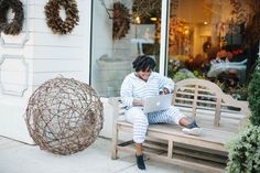 a woman sitting on a bench using a laptop