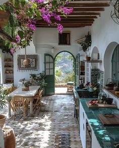 an open kitchen and dining area with potted plants on the counter tops, pots hanging from the ceiling