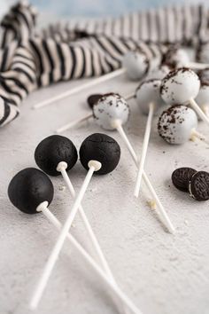 chocolate covered oreo cookies and marshmallows on sticks