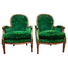 a pair of green chairs sitting next to each other