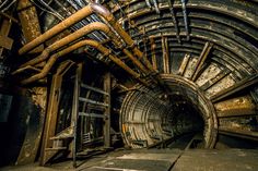 the inside of a tunnel with pipes running through it