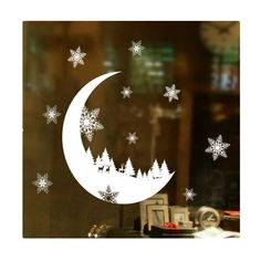 the window is decorated with white snowflakes and a crescent shaped tree on it