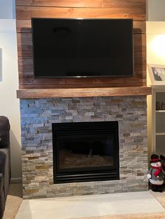 a flat screen tv mounted above a fireplace