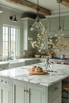 a kitchen with marble counter tops and green cabinets