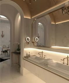 a large bathroom with two sinks and mirrors