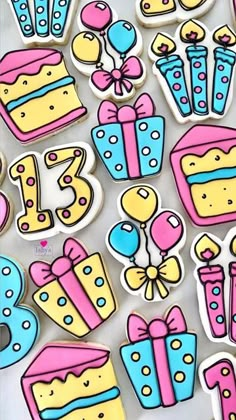 decorated cookies are arranged in the shape of numbers and birthday cakes on white paper