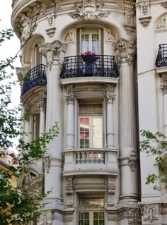 an ornate white building with balconies and windows