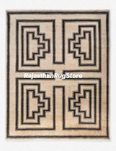 an old rug with black and white designs on it's sides, in the shape of four rectangles