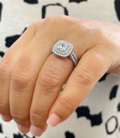 a woman's hand with a diamond ring on it