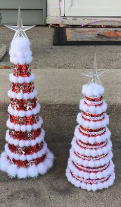 two red and white christmas trees with stars on top, one decorated like a tree