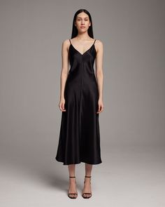 This elegant bias-cut slip dress features a spaghetti strap and flattering V Neck for a fresh, yet refined look. This perfect basic can be worn for life, dressed up, or dressed down, for the perfect effortless ensemble. 100% Silk Charmeuse Made in New York City Product Care: Dry Clean Only Fitted V-neck Bias Cut Slip Dress, Satin V-neck Lined Slip Dress, Silk V-neck Slip Dress With Delicate Straps, Luxury V-neck Bias Cut Slip Dress, Black Satin V-neck Slip Dress, Nylon Dress, Peasant Blouse, Silk Charmeuse, Engineered Garments