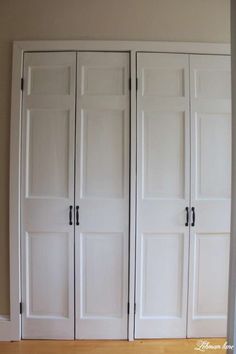 three white closet doors in a room