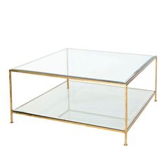 a glass and brass coffee table with two shelves on the bottom, one shelf is empty