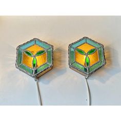 two green and yellow stained glass wall lights