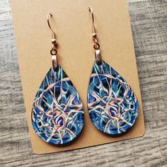 This pair of lightweight, teardrop earrings adds a unique touch, featuring original neuro-inspired artwork, "Cycle of Thought". They are artsy, vibrant and a creative way to advocate for healthy thought patterns. A unique accessory for anyone needing a gentle reminder, but also eye-catching jewelry for those in neuroscience, counseling or medical professions. "We have the power to reclaim our thought life through the simple practice of being aware of our every notion. Even the smallest thoughts can grow in influence to lead us into either a cycle of chaos and despair or life-giving peace and hope." If you are interested in the original artwork that inspired this item or seeing more from the art collection, visit Geinene.com or follow me on Instagram @Geinene .: Made from lightweight, MDF w Artistic Abstract Drop Earrings, Artistic Abstract Design Drop Earrings, Artistic Teardrop Earrings, Artistic Teardrop Earrings With Artistic Design, Artsy Abstract Design Drop Earrings, Artsy Teardrop Earrings With Ear Wire, Artsy Blue Teardrop Earrings, Nickel-free Teardrop Artsy Earrings, Gift Abstract Design Drop Earrings