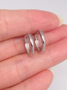 925 Sterling Silver Plain Huggie Hoop Earrings    - Metal: 925 Sterling Silver (Finish: Rhodium Plated) - Shape: Round Huggie Hoop  - Dimension:  Outer Diameter 14.5mm(0.57 in), Inner Diameter 11.5mm (0.45 in), Face Width 1.9mm. - Closure: Leverback  - Color: Silver Sterling Silver Huggie Earrings With Shiny Finish For Anniversary, Classic Hypoallergenic Silver Huggie Earrings, Silver Round Huggie Earrings With Polished Finish, Sterling Silver Huggie Jewelry With Shiny Finish, Hypoallergenic Sterling Silver Round Huggie Earrings, Hypoallergenic Round Sterling Silver Huggie Earrings, Sterling Silver Huggie Earrings With Shiny Finish, Silver Huggie Rings For Gifts, Tarnish Resistant White Gold Huggie Earrings