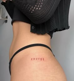 a woman's lower back with the word energy written on it in cursive font