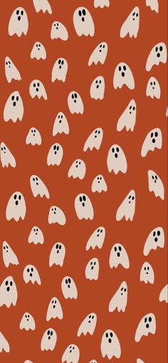 an orange background with white ghost faces on it