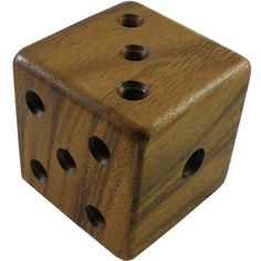 a wooden dice with holes in the middle