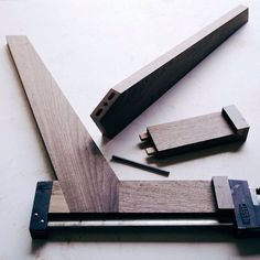 a couple of pieces of wood sitting on top of a white table next to a pair of scissors