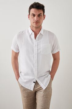 DETAILS | Lightweight cotton, short sleeve, crisp white collared buttondown shirt featuring relaxed fit, patch pocket at chest, and sustainable corozo buttons. This super soft, laidback shirt is perfect for any occasion from work to weekend. 100% Cotton. Imported. CARE | Machine Wash Cold Separately. Gentle Cycle. Do Not Bleach. Tumble Dry Low. Cool Iron If Needed. Or Dry Clean. FIT | Recommend ordering true to size. Front Body Length: 30 1/2" (Measured from Large) Model is wearing size M.Model' Button Down Shirt, Relaxed Fit, How To Wear