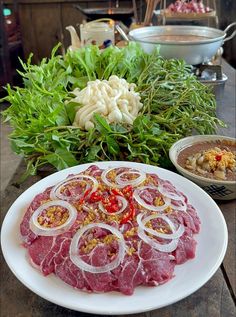 a white plate topped with meat and onions