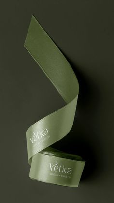 a green satin ribbon with the word vuka on it