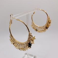 Gold star hoop earrings. Gold star charms dangling from a gold hoop earrings. They measure 1.5 inches wide. These earrings are very pretty, fun, trendy hoop earrings. These earrings will go great with the perfect dress, tee shirt, or any outfit! They make a perfect gift for anyone you have in mind. Celestial Style Yellow Gold Hoop Earrings, Star-shaped Hoop Earrings With Star Charm For Party, Elegant Gold Star-shaped Hoop Earrings, Gold Star-shaped Celestial Hoop Earrings, Celestial Star-shaped Hoop Earrings With Moon Charm, Big Star, Gold Hoop, Star Charms, Gold Stars