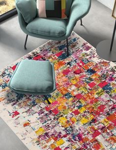 a chair and ottoman on a rug in a room