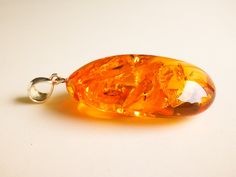 "What an exquisite amber piece - intense shiny cognac color medium size amber pendant with golden rays inside. Shaped into a beautiful oval shape it looks royal and high-value. Its high quality shines as bright as little rays of the sun. MATERIALS AND SIZE: Stone: 100% Natural Baltic Amber Other materials: silver 925 Weight: 13 g (0,45 oz) Pendant size: 4,5 cm (1,77 in) x 2,8 cm (1,10 in) Total length: 5,9 cm (2,32 in) PLEASE NOTE: All our amber production is made of natural amber. Amber is an u Orange Teardrop Jewelry For Formal Occasions, Oval Baltic Amber Necklace, Amber Cabochon Oval Pendant Jewelry, Oval Baltic Amber Gold Jewelry, Formal Oval Amber Necklace, Baltic Amber Pendant Necklace, Amber Pendant Necklace In Baltic Amber, Gold Baltic Amber Round Necklace, Gold Baltic Amber Necklace