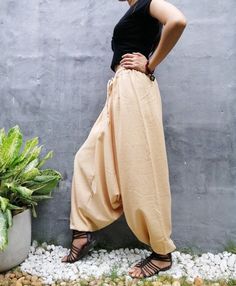 "The harem style trousers made from cotton fabric 100%with an elasticated smock waist and ankles they provide a comfortable lightweight fit, perfect for casual wear, festivals, yoga, holidays as well as pairing with a plain top to get that popular look. D I S C O U N T & P R O M O T I O N ❤ Buy 2 or more items, get 10% off ❤ Buy 4 or more items, get 15% off ENTER the coupon code: IYARA015 ❤ Buy 6 or more items, get 15% off ENTER the coupon code: IYARA020 PLEASE NOTE I can not apply a discoun Cotton Harem Pants For Spring, Beige Harem Bottoms For Summer, Summer Beige Harem Bottoms, Beige Harem Pants For Summer, Hippie Harem Pants With Elastic Waistband, Baggy Harem Pants With Elastic Waistband In Hippie Style, Baggy Hippie Harem Pants With Elastic Waistband, Casual Beige Harem Bottoms, Bohemian Beige Harem Pants For Spring