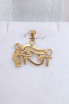 "Egyptian carving Pendant Handmade Eye Of Horus + Ankh Cross 18K Gold 2.2 Gr Weight Approximate : 2.2 Gr Height : 0.7\" = 19 mm Width : 0.9\" = 24 mm ✔ IT IS Tested & SIGNED WITH THE EGYPTIAN Gold Government HALLMARK FOR 18K GOLD to Ensure Authenticity. ✔ Lovely gift idea ABSOLUTELY GORGEOUS, LOOKS FABULOUS ON. ✔ 100% Egyptian handmade. ✔ Condition: A brand-new, exactly as on the photos. ★ GIFTS ✔ All items are packaged in a paper jewelry gift box, ready for gifting. ✔ If you are sending a gift Carved 14k Gold Jewelry, Traditional 14k Gold Collectible Jewelry, Symbolic 14k Gold Jewelry With Intricate Design, Gold Carved Jewelry As Gift, Symbolic Gold Jewelry With Filigree Details, Antique Engraved 22k Gold Jewelry, Antique 22k Gold Engraved Jewelry, Symbolic Carved Gold Jewelry, Traditional Carved Yellow Gold Jewelry