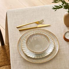 a place setting on a table with goldware