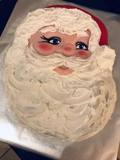 there is a cake that looks like santa claus on the table with white frosting