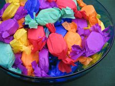 a bowl filled with lots of different colored tissue paper