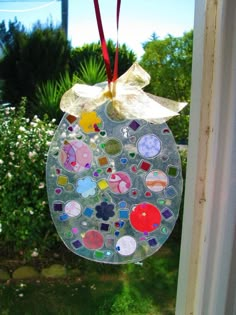 a glass ornament hanging from a window