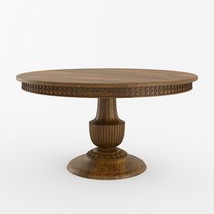 a round wooden table with an intricately carved design on the top and base, against a white background