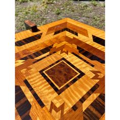 a close up of a wooden table with many different shapes and sizes on it's surface