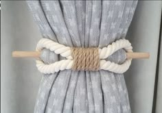 a close up of a curtain with ropes attached to the top and bottom of it