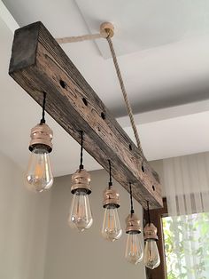 a wooden beam with five light bulbs hanging from it