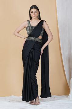 Ooze style and class in this ready to wear saree in a stunning black hue. With a contrasting blouse and belt, this saree is a classic pick for cocktail parties, soirées and weddings!Style Ready to Wear Saree Embellished Belt Contrasting Blouse Classic Black hue Armani silk fabric Specifications Model height - 5'9" Model wearing - S Floor-length Evening Blouse With Cutdana, Evening Georgette Pre-draped Saree With Side Open, Festive Black Pre-draped Saree With Self Design, Formal Floor-length Pre-draped Saree For Diwali, Festive Evening Pre-draped Saree With Cutdana, Elegant Party Pre-draped Saree With Zari Work, Black Georgette Bollywood Pre-draped Saree, Black Pre-draped Saree With Pallu For Festive Occasions, Fitted Pre-draped Saree With Zari Work For Evening