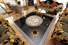 an elaborately decorated living room with black and gold furniture