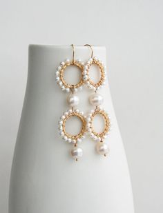 ★★★A modern take on pearls while also keeping it traditional. I've mixed small and large pearls for a unique look. These statement earrings will be a showstopper on your wedding day.+ Freshwater Pearls. 14K Gold Fill Ear Wire. 14K Gold Plate Circles.+ Length: 2.75 inches.+ Earrings take 1 business day to make.+ Your jewelry will come in a jewelry box, tied with a ribbon.➤➤ Have a question about this product, reach out to me here ➙ https://www.etsy.com/conversations/new?with_id=9057464&referr Elegant White Cluster Earrings With Pearl Drop, Elegant White Pearl Drop Cluster Earrings, White Pearl Cluster Earrings With Pearl Drop, White Pearl Drop Cluster Earrings For Anniversary, Gift White Pearl Chandelier Earrings, Handmade Elegant Pearl Beaded Earrings, Handmade Elegant Round Pearl Earrings, White Akoya Pearl Earrings With Pearl Charm, Elegant Pearl Drop Earrings With Round Beads