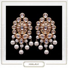 Kundan work inspired Indian earrings with high graded shell pearls. Earrings based in silver and copper alloy and embellished with faux glass polki. Wear this with almost anything Indian for a rich and royal look because nothing more regal than kundan earrings. Details Handcrafted Metal Gold Plated Stone Shell Pearls Semi Precious Kundan Dimensions Length 4 inches / Width 2.5 inches Stud Earrings Closure Post Tikka can be added to these earrings. Elegant Silver Kundan Chandelier Earrings, Elegant Kundan Pearl Earrings With Stone Work, Elegant White Kundan Earrings, Fusion Style Kundan Pearl Earrings With Meenakari, Elegant Metal Kundan Necklace With Meenakari, Elegant Metal Chandbalis With Meenakari, Elegant Pearl Earrings With Stone Work For Diwali, Elegant Metal Meenakari Chandbalis, Festive Fusion Style White Danglers