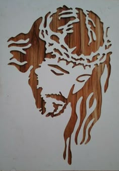 a wooden cutout of jesus with his head in flames