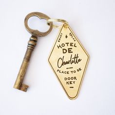 a keychain with a hotel de charlotte sign attached to it