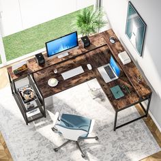 an overhead view of a desk with two laptops and a desktop computer on it