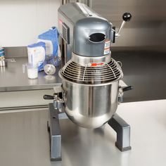 a silver mixer sitting on top of a counter