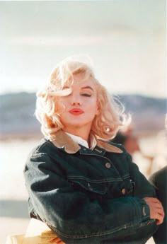 a woman with blonde hair sitting on a bench